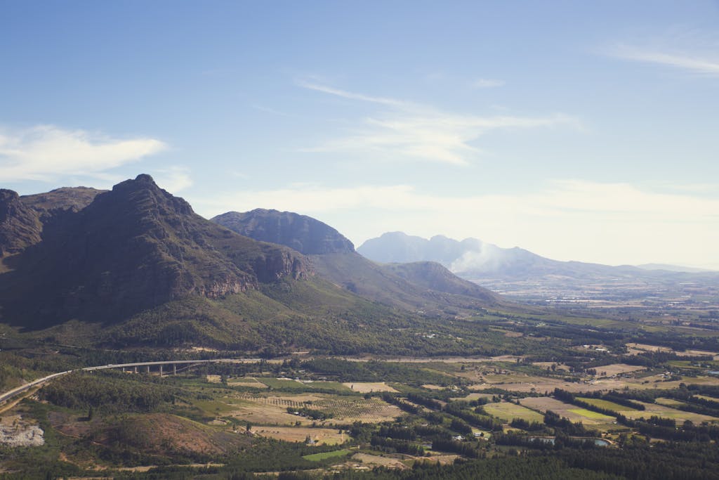 A breathtaking view of South African mountains and rural landscape on a clear day.
