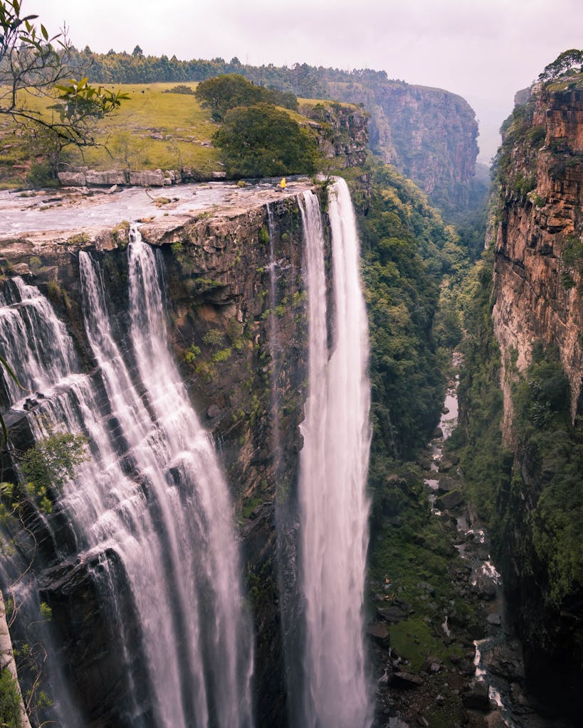 Dramatic view of a serene waterfall in Mpumalanga, surrounded by lush greenery.