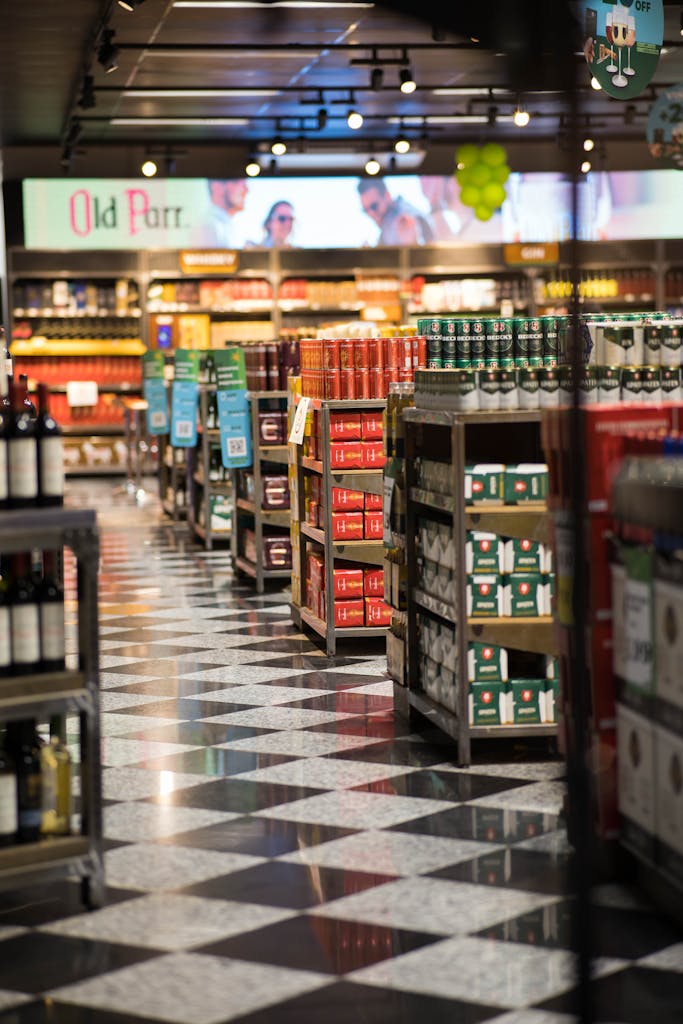 A quiet evening in a grocery store with neatly stacked products and checkered floors.