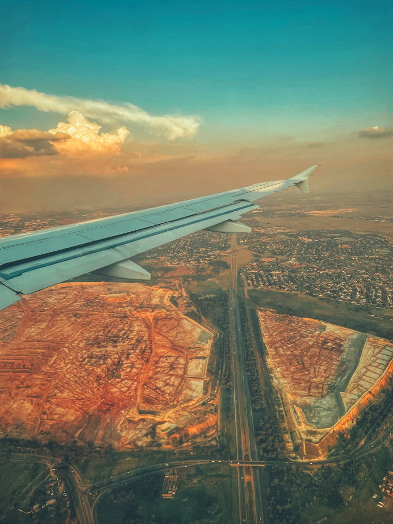 A striking aerial view of Johannesburg, capturing urban sprawl and the natural landscape from the airplane window.