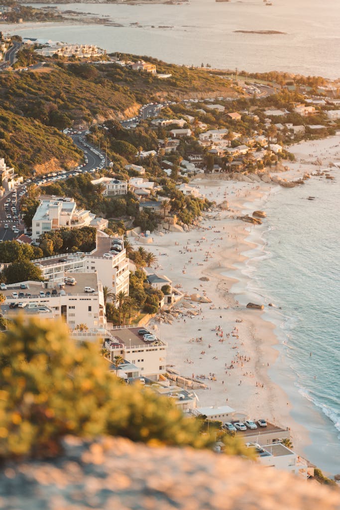 Aerial view of Cape Town's beautiful beaches and coastal buildings at sunset.