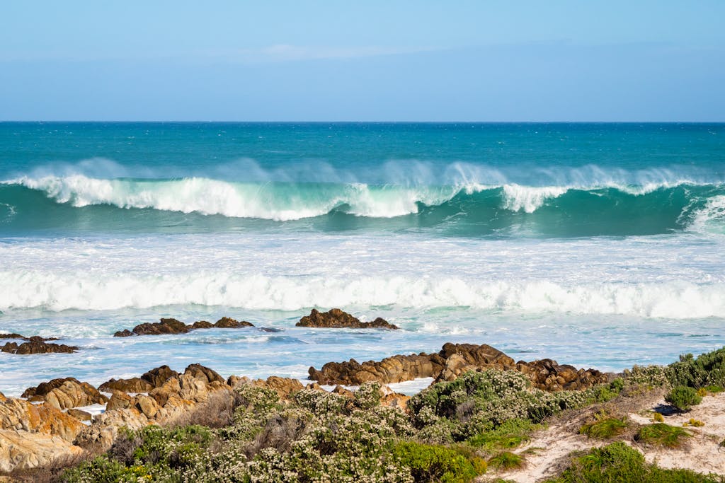 Scenic view of waves crashing on the rocky shore at Pearly Beach, South Africa.