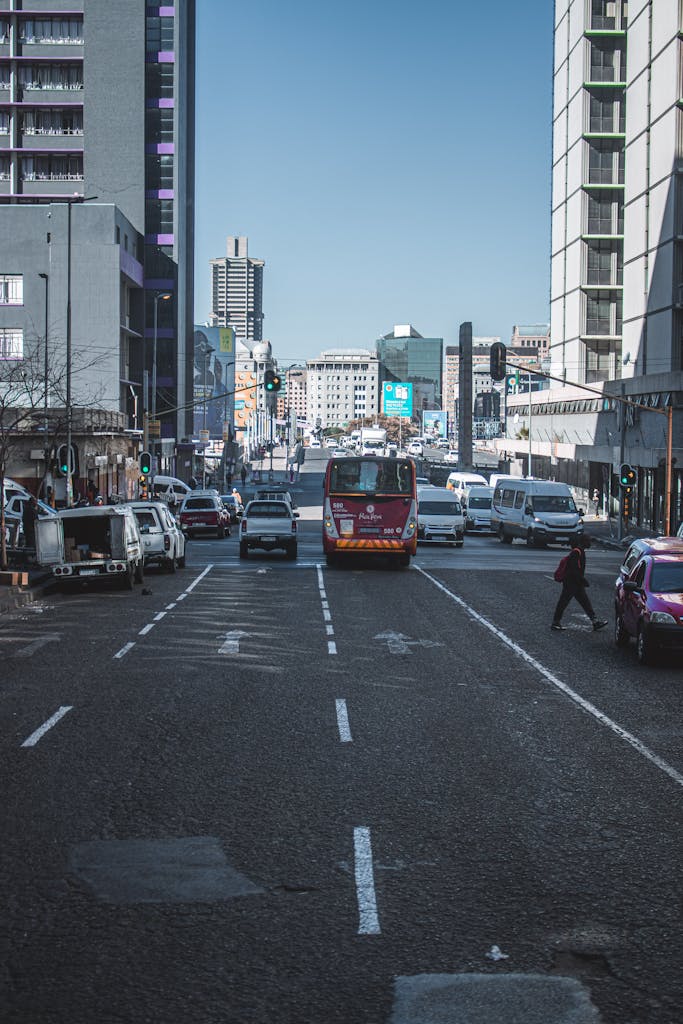Urban traffic and city life captured on a busy street in Johannesburg, South Africa.
