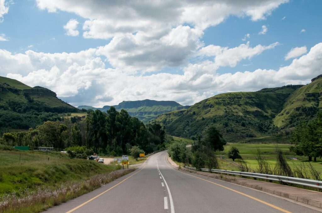 Captivating view of a highway winding through lush green hills in South Africa.